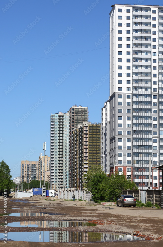 Unfinished road in the area of modern new buildings, ulitsa Dybenko, Saint Petersburg, Russia, May 2021