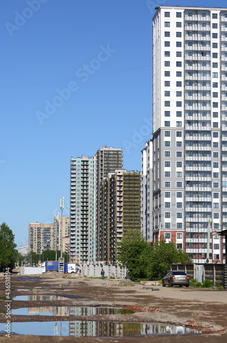 Unfinished road in the area of modern new buildings, ulitsa Dybenko, Saint Petersburg, Russia, May 2021
