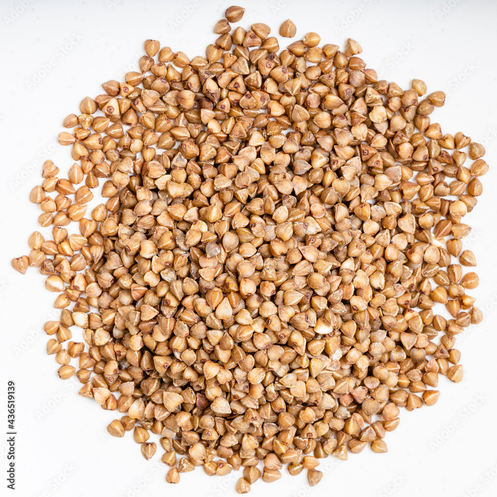 pile of roasted buckwheat grains close up on gray