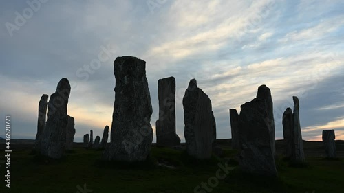 Time lapse of sky movement at sunset over Callanish stones, Isle of Lewis, Outer Hebrides. Stones are silhouetted against sky. No people.