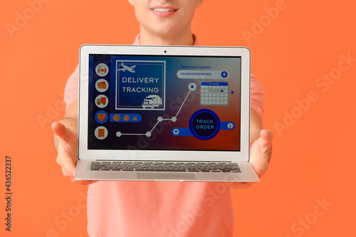 Young man and laptop with o...