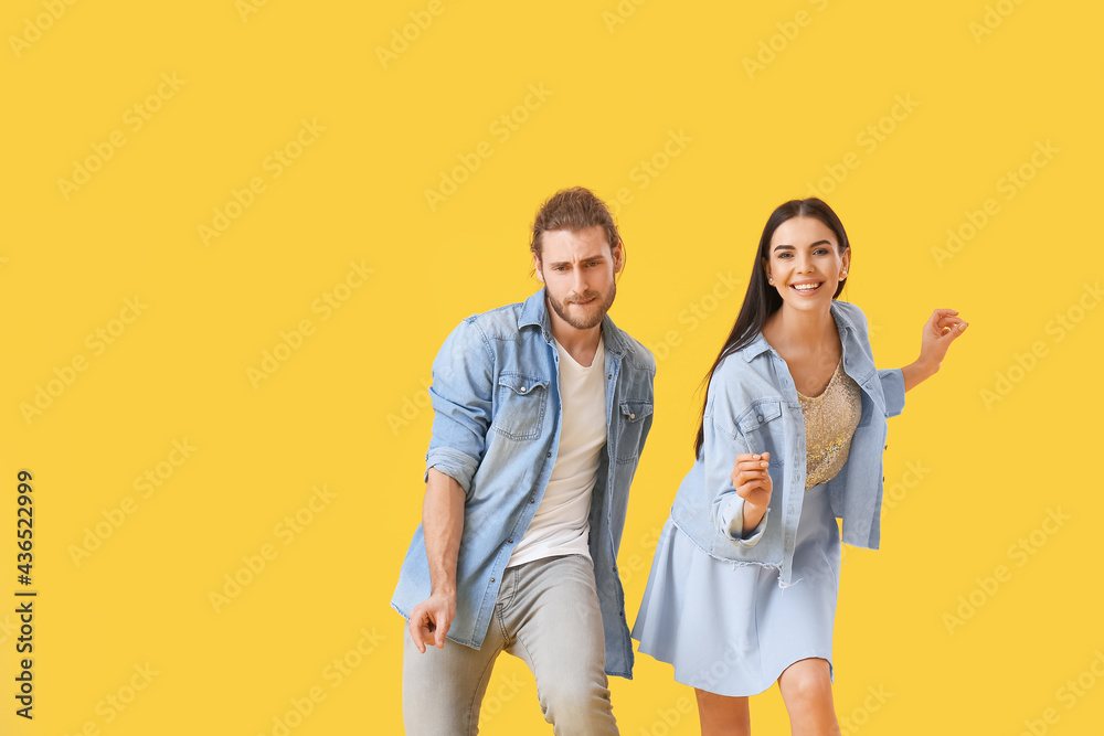 Happy young couple dancing on color background Happy young couple dancing on color background
