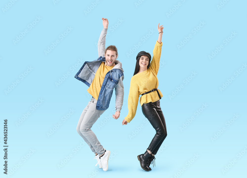 Happy young couple dancing on color background Happy young couple dancing on color background