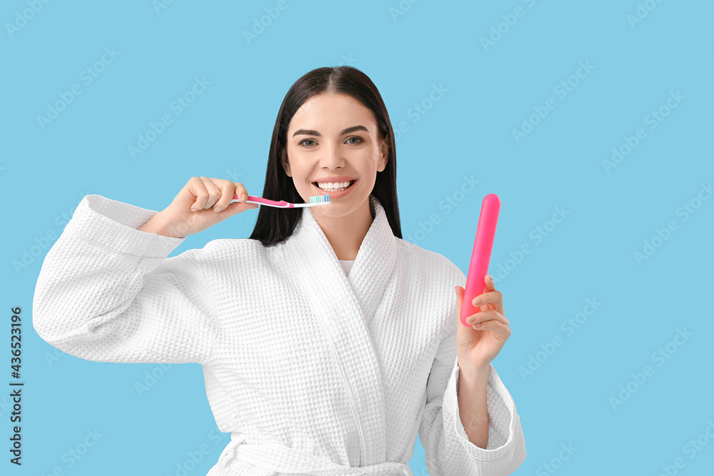 Young woman brushing teeth on color background Young woman brushing teeth on color background