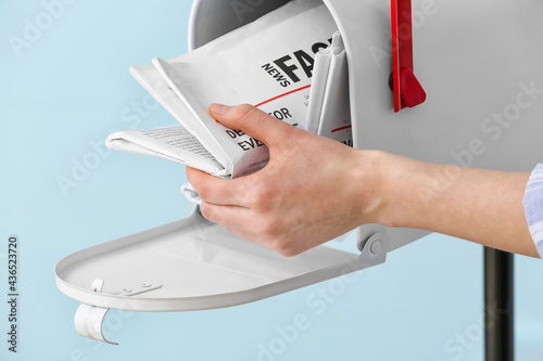 Woman getting newspaper fro...