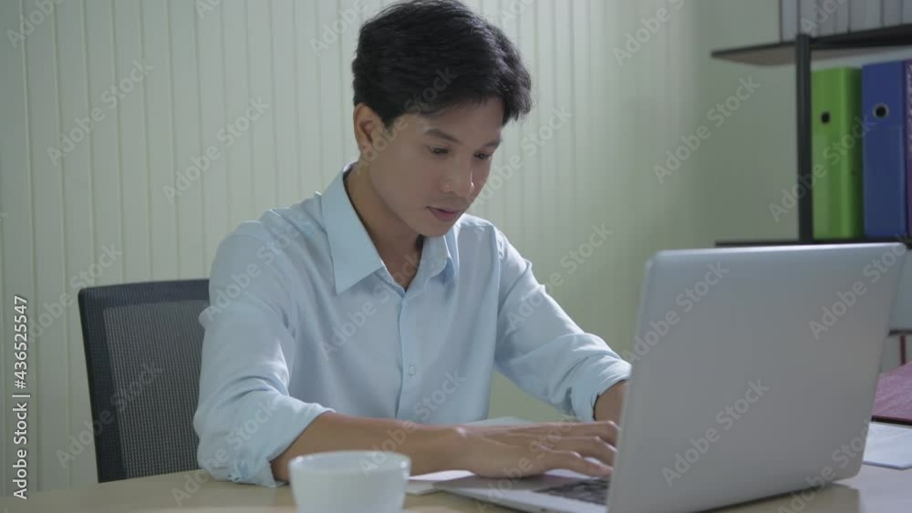 Business concept of 4k Resolution. Young Asian men searching for information using a computer. Business concept of 4k Resolution. Young Asian men searching for information using a computer.