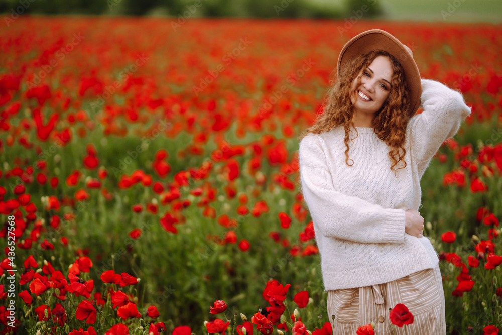 Young woman walking in amazing poppy field. Summertime. Beautiful woman posing in the blooming poppy field. Nature, vacation, relax and lifestyle. Young woman walking in amazing poppy field. Summertime. Beautiful woman posing in the blooming poppy field. Nature, vacation, relax and lifestyle.