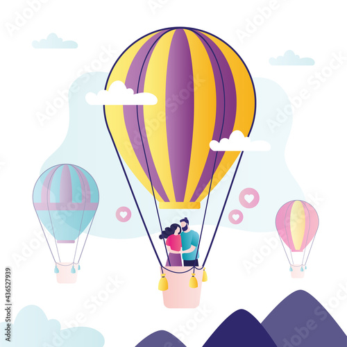 Cute love couple flying in large hot air balloon. Happy family have  travel adventure. Happy people celebrate anniversary.