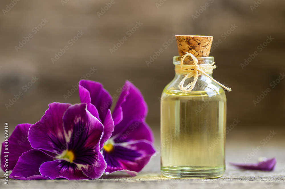 Glass bottle of essential pansy oil with fresh violet flowers, beauty  treatment, alternative medicine Stock Photo | Adobe Stock