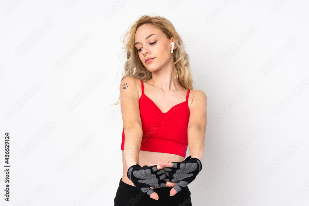 Young blonde woman isolated on white background stretching arm Young blonde woman isolated on white background stretching arm