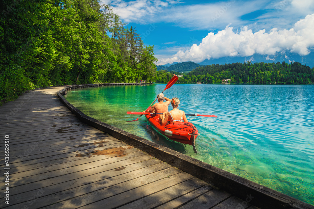 Fototapeta premium Active couple canoeing and enjoying the view, lake Bled, Slovenia