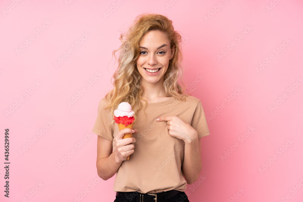 Young blonde woman holding a cornet ice cream isolated on pink background with surprise facial expression Young blonde woman holding a cornet ice cream isolated on pink background with surprise facial expression