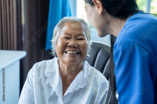 Happy elderly woman,Nurse giving psychological help and talking with elderly woman in a nursing home.