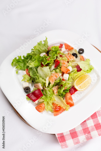 seafood salad with vegetables on white plate