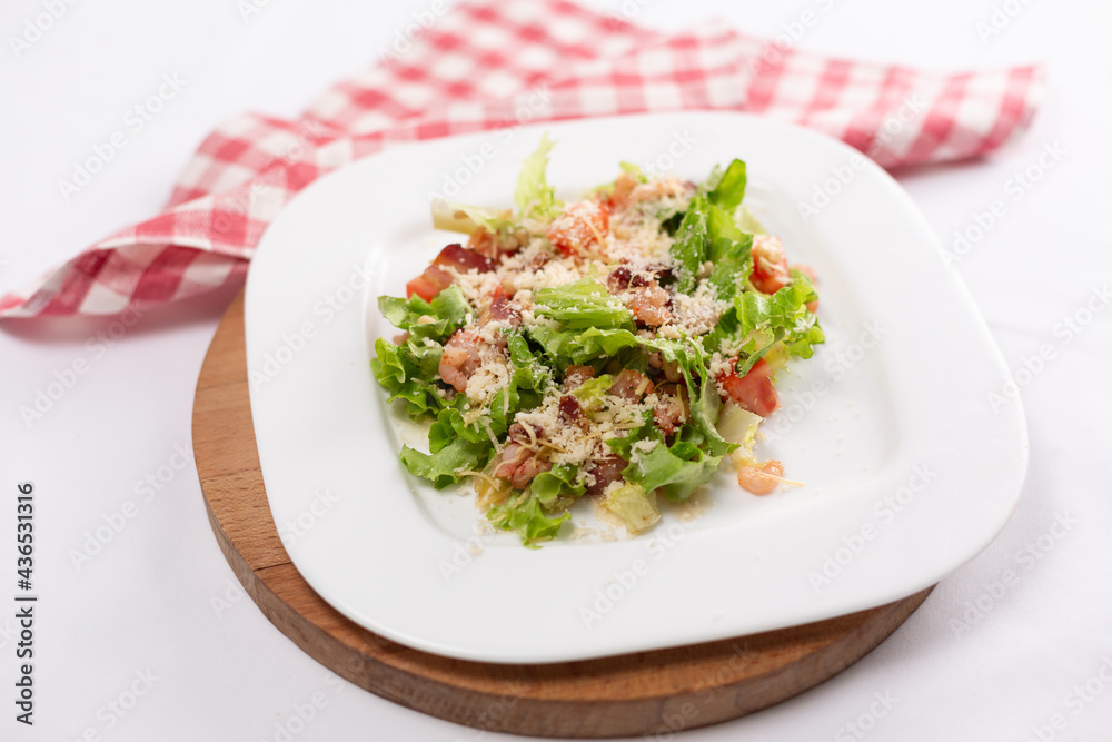 Caesar salad with shrimps on a white plate Caesar salad with shrimps on a white plate