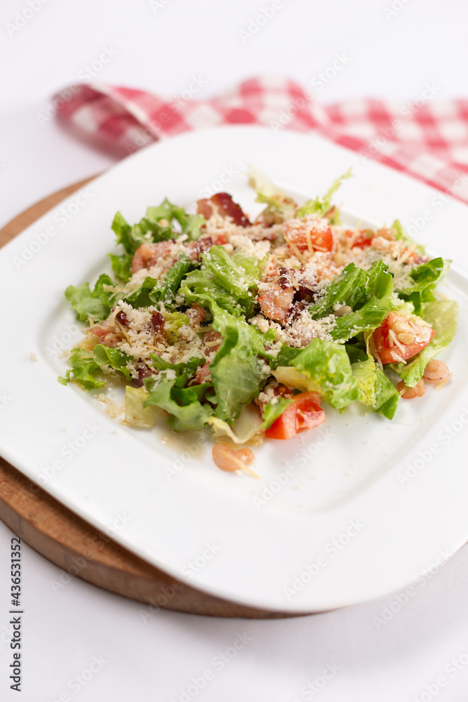 Caesar salad with shrimps on a white plate Caesar salad with shrimps on a white plate