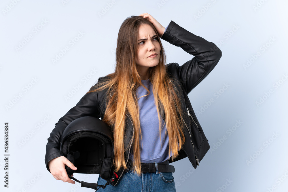 Woman with a motorcycle helmet having doubts and with confuse face expression Woman with a motorcycle helmet having doubts and with confuse face expression
