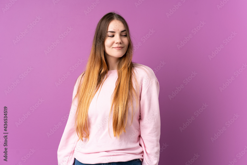Young caucasian woman isolated on purple background having doubts while looking side Young caucasian woman isolated on purple background having doubts while looking side