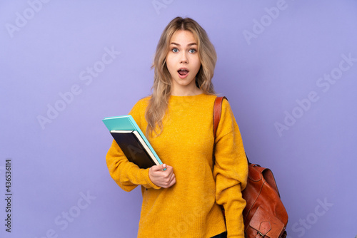 Teenager Russian student girl isolated on purple background with surprise facial expression