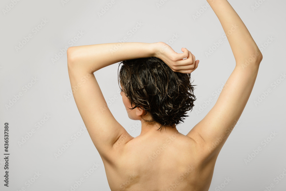 Back view of a woman with arms up. Stock Photo