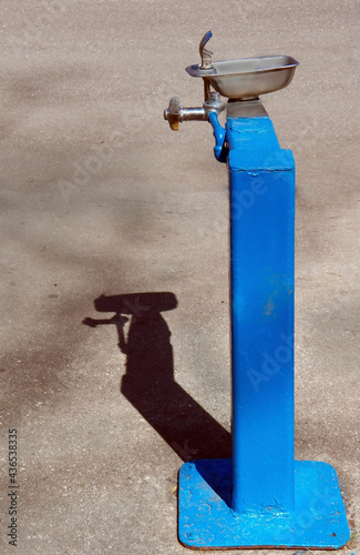 Royal blue water fountain with shadow.