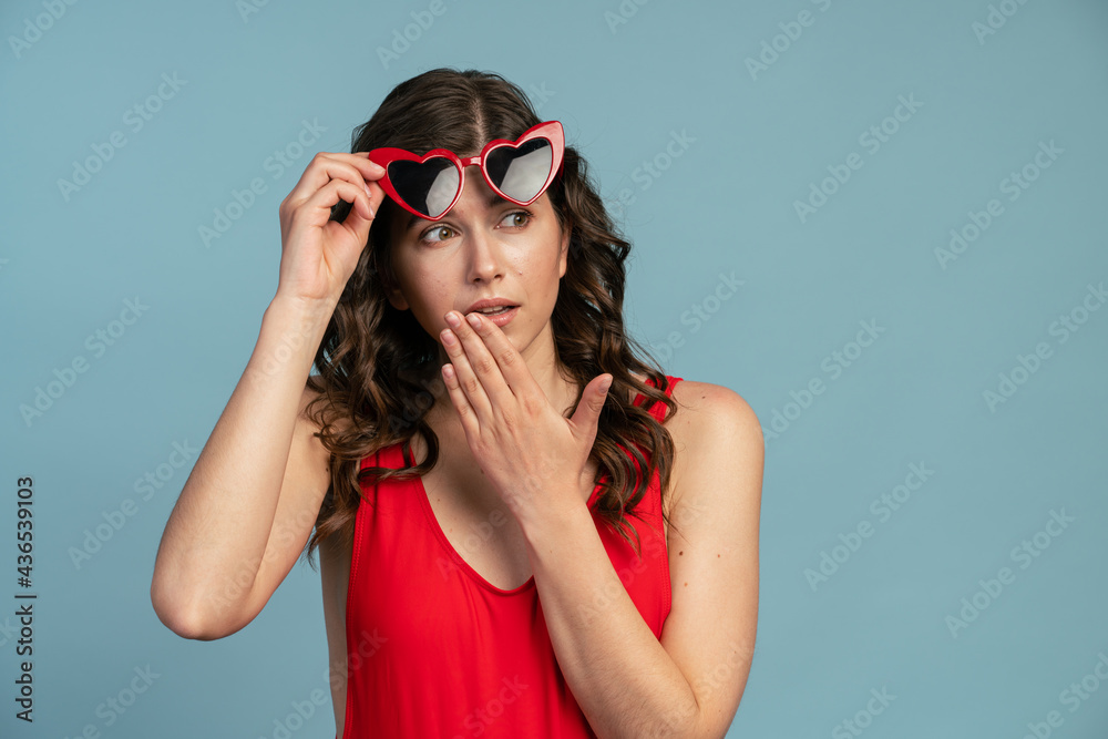 Attractive, young girl looks excitedly to the side, raising her Attractive, young girl looks excitedly to the side, raising her
