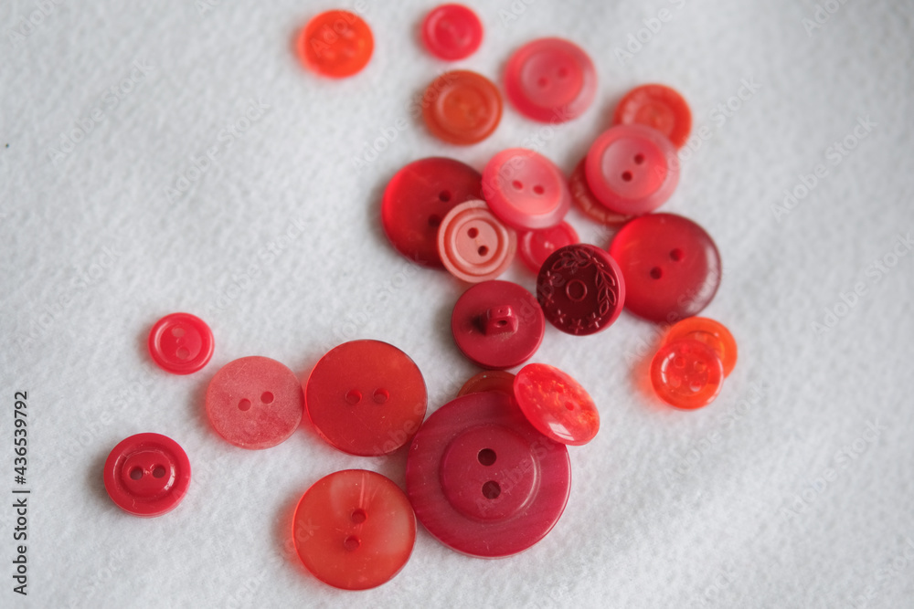 old plastic buttons in different colors on the background. old plastic buttons in different colors on the background.
