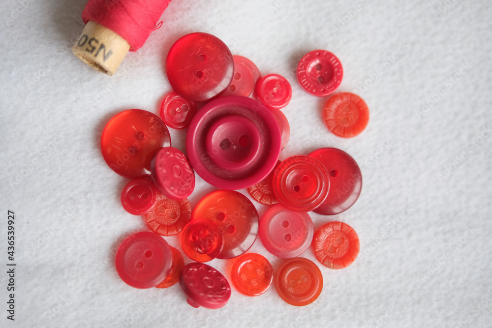 old plastic buttons in different colors on the background. old plastic buttons in different colors on the background.