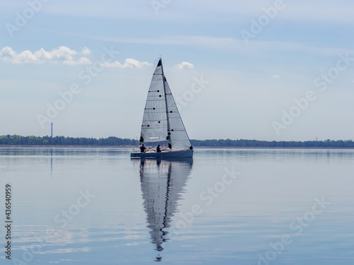 Sailing yacht on the background of water and blue sky. Kyiv, Ukraine 