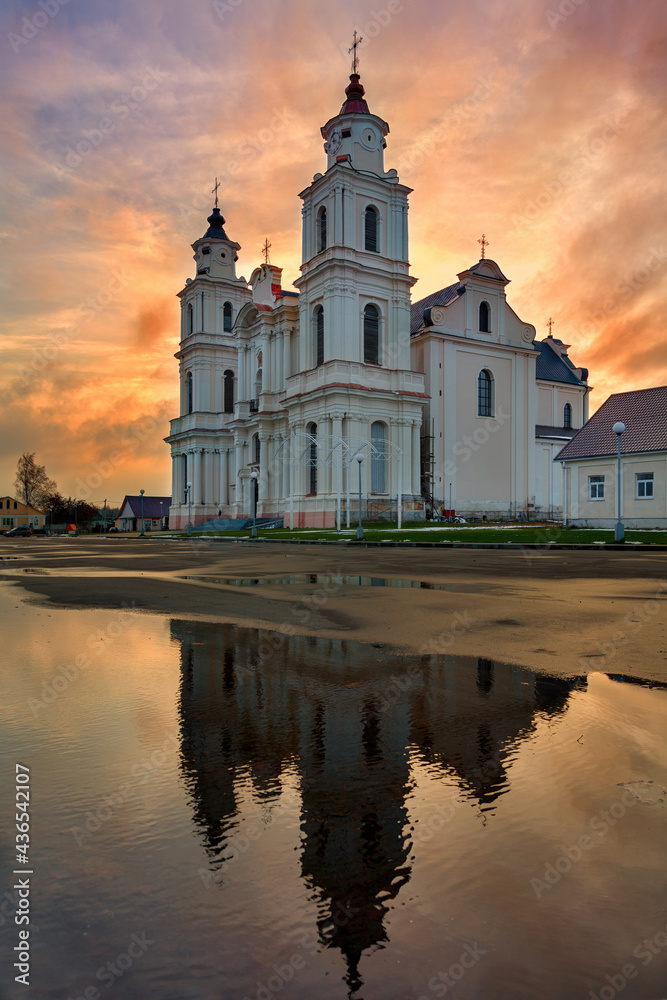 Catholic church in Budslau (Belarus) in the evening, against the backdrop of a beautiful sunset
