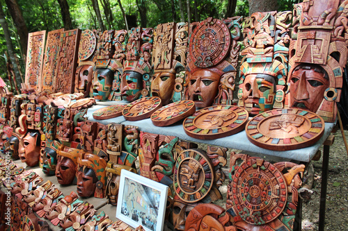Wooden mayan mask on the handicraft market selling traditional mexican souvenirs at Chichen Itza, Yucatan, Mexico. Souvenir stalls at the Chichen Itza. photo