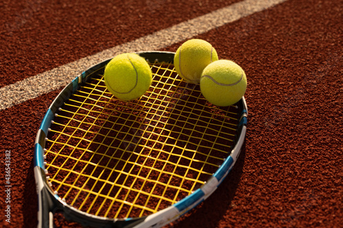 Tennis Ball with Racket on the racket in tennis court © Angelov