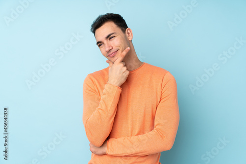 Young caucasian handsome man isolated on blue background smiling