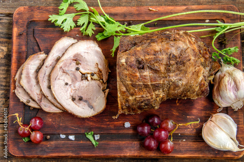 Roasted Beef with some slices on a wooden table