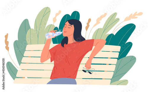 Girl enjoying drinking water while sitting on a park bench