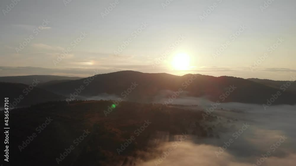 Aerial top drone view above the clouds and sky in wonderful morning sunrise time. Inspiration concept. Flying through the clouds above mountain tops. Beautiful sunset mountain ridge Aerial top drone view above the clouds and sky in wonderful morning sunrise time. Inspiration concept. Flying through the clouds above mountain tops. Beautiful sunset mountain ridge