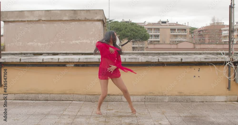 beautiful Indian classical dancer is practicing on the terrace