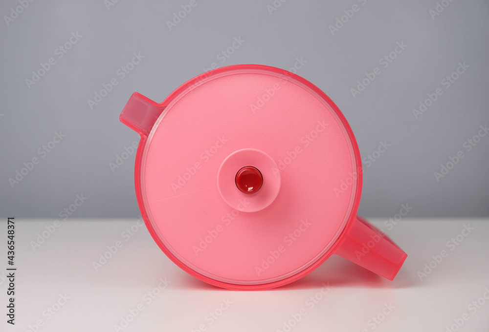 Red water jug isolated on a grey and white background Stock Photo