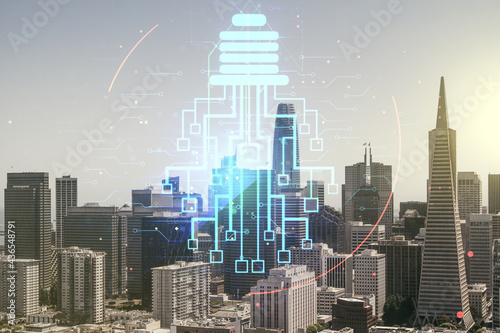 Double exposure of virtual creative light bulb hologram with chip on San Francisco city skyscrapers background, idea and brainstorming concept