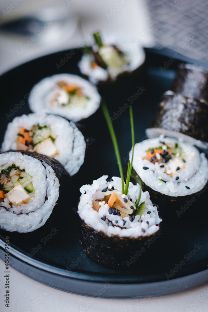 Vegan vegetarian sushi roll on the black plate Vegan vegetarian sushi roll on the black plate