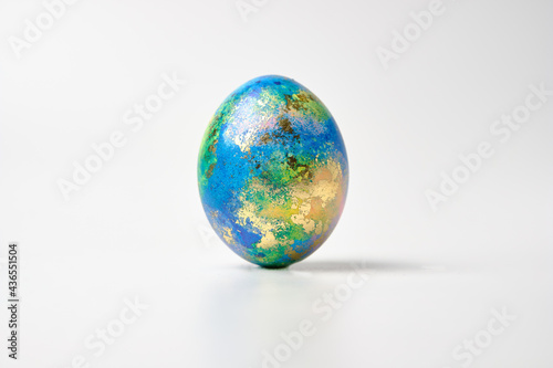 Fototapeta Naklejka Na Ścianę i Meble -  Easter eggs. Easter background. Easter. Copy cpase egg isolated on a white background painted like planet earth, a workpiece for the designer.