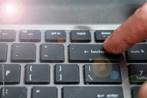 Laptop keyboard close up, backspace button pressing a lot of times on keyboard photo