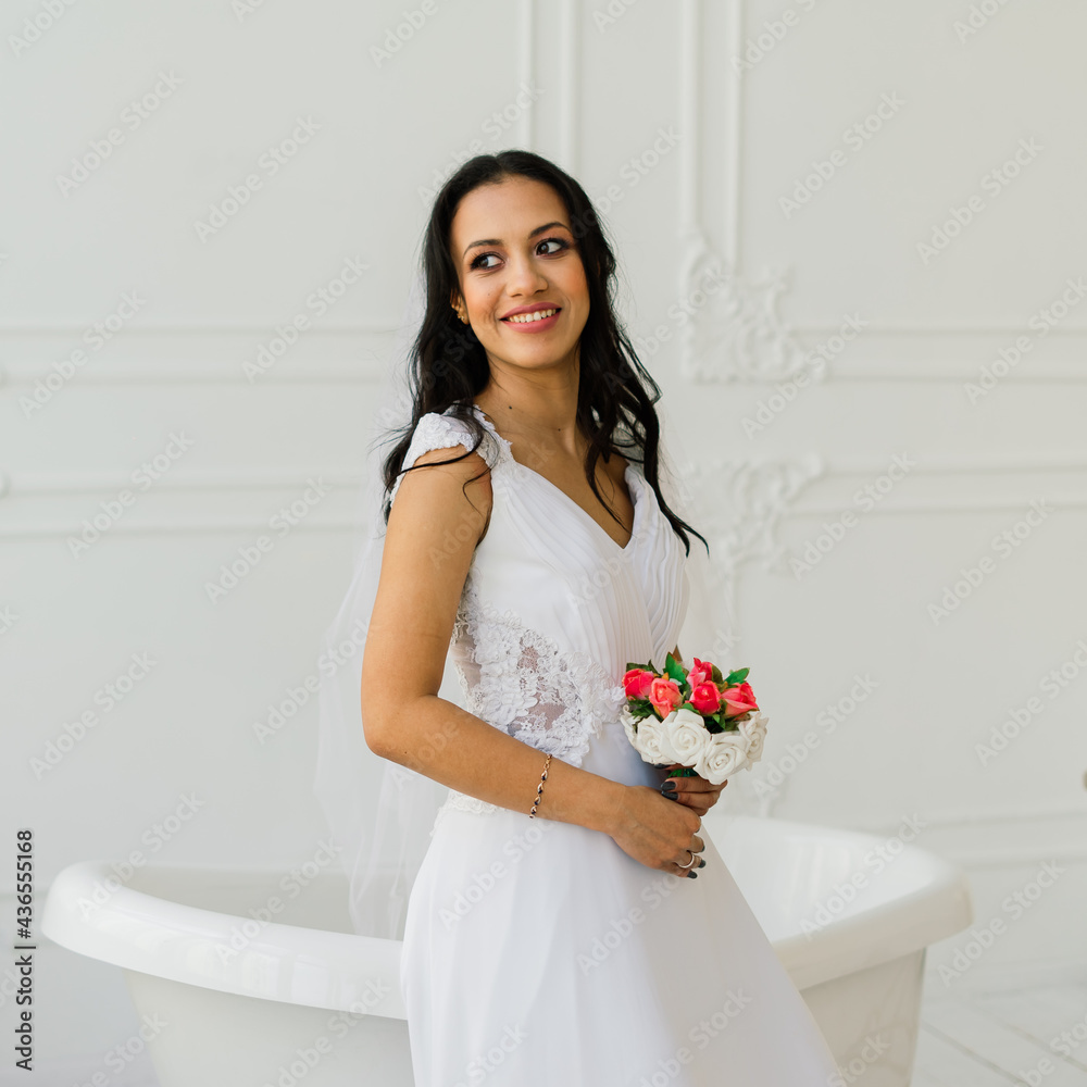 Happy beautiful bride with her veil smiling and excited in interior, wedding morning Happy beautiful bride with her veil smiling and excited in interior, wedding morning