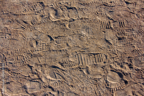 Many shoe sole footprints on sand. Walk path. Holiday concept