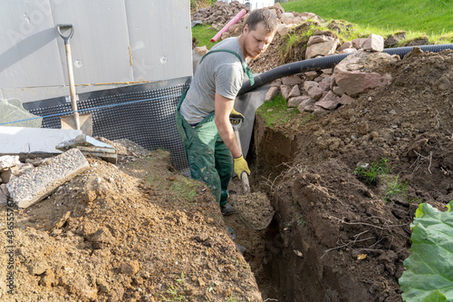 Digging ground to make drainage home.