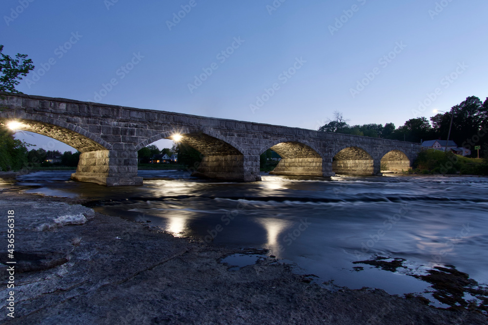 A bridge over a river at dusk