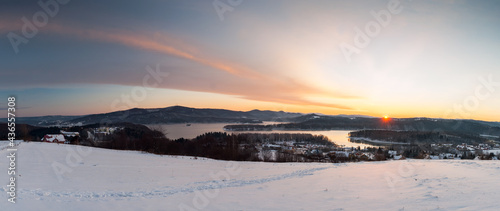 Fototapeta Naklejka Na Ścianę i Meble -  The January sunrise over Lake Solina seen from the viewpoint in Polańczyk. Polanczyk, Bieszczady Mountains.