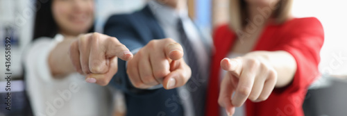 Successful business partners pointing finger in front of them closeup