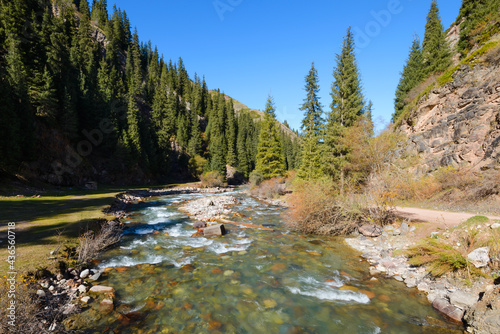 River flowing at Jeti Oguz Valley in Kyrgyzstan pine with trees and rocks. Djety Oguz is becoming a tourist destination for nature lovers in Central Asia. photo