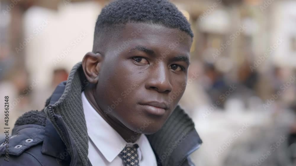 thoughtful black businessman in the crowded street staring at camera thoughtful black businessman in the crowded street staring at camera